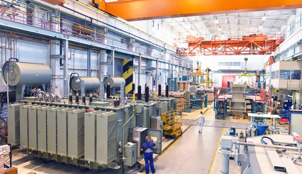 Industrial manufacturing plant with conveyor belts and workers.